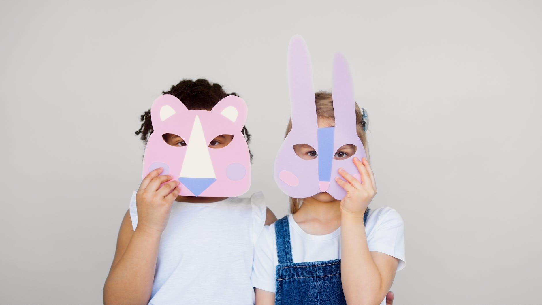 two kids covering their faces with a cutout animal mask two kids covering their faces with a cutout animal mask two kids covering their faces with a cutout animal mask two kids covering their faces with a cutout animal mask two kids covering their faces with a cutout animal mask