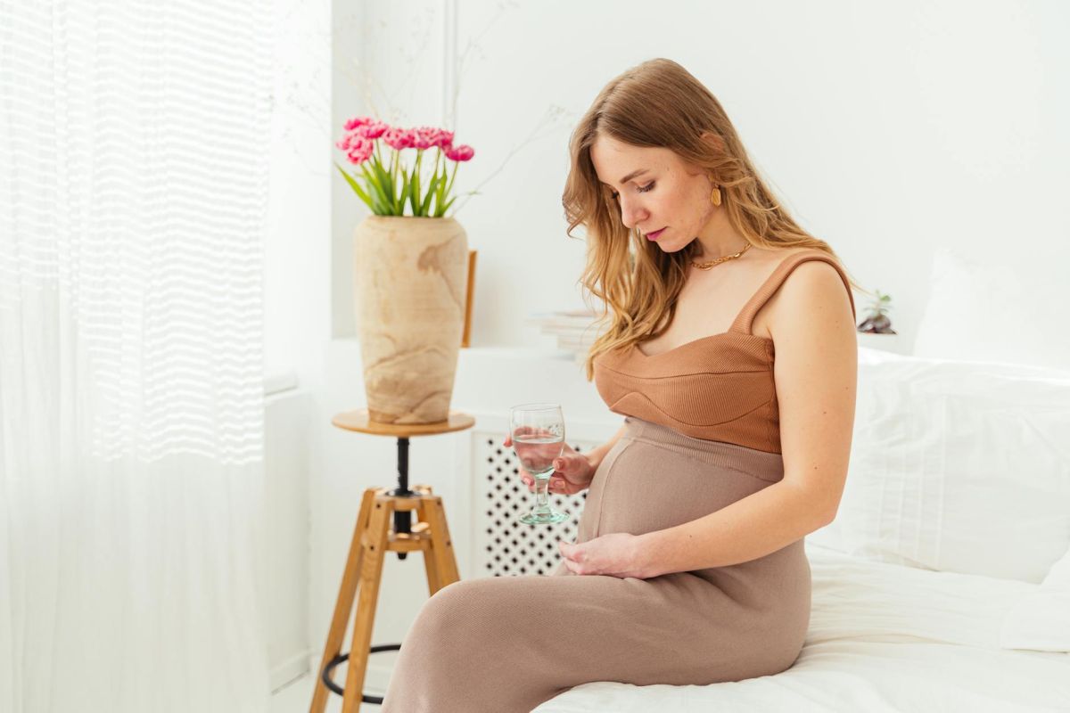 a pregnant woman staring at her baby bump