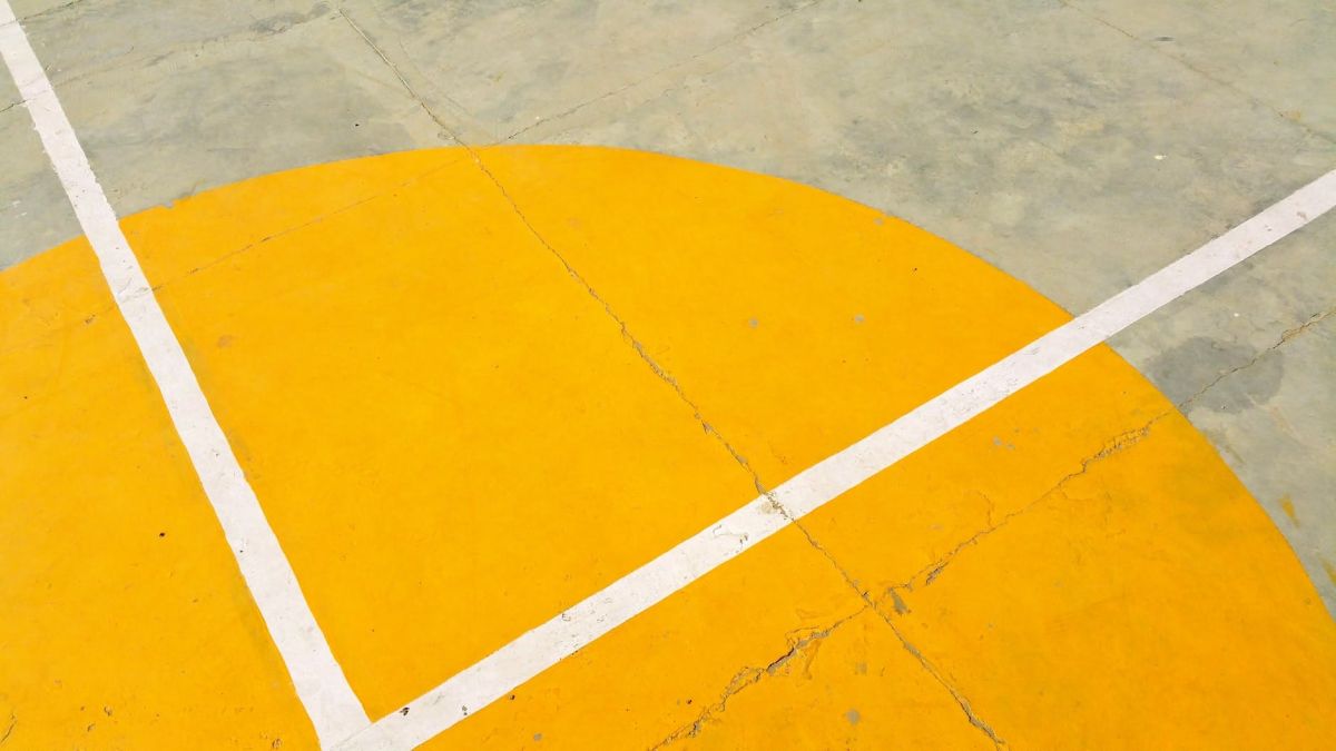 gray concrete pavement with yellow and white paint